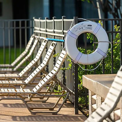 Pool lounge chairs and life preserver