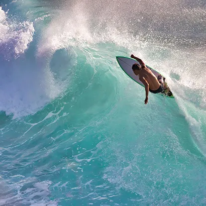 Surfer catching a wave in Maui, Hawaii